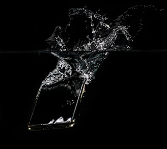 A waterproof phone pouch floating on a crystal-clear pool surface with a smartphone inside.