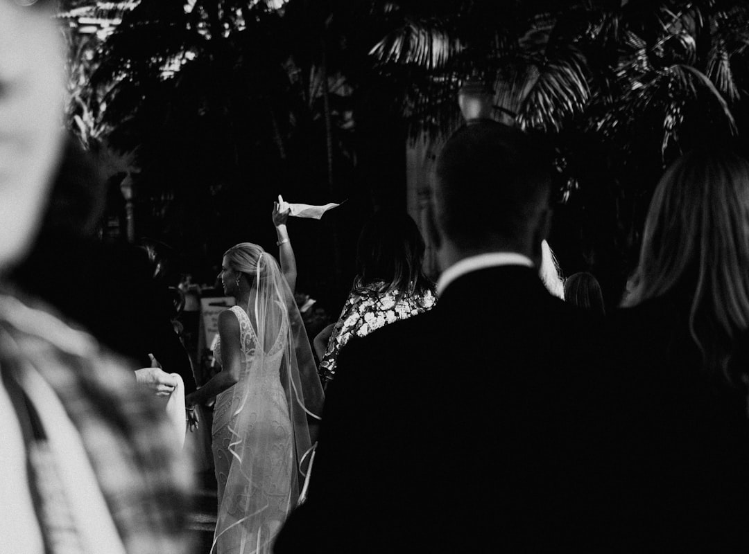 grayscale photo of man and woman kissing