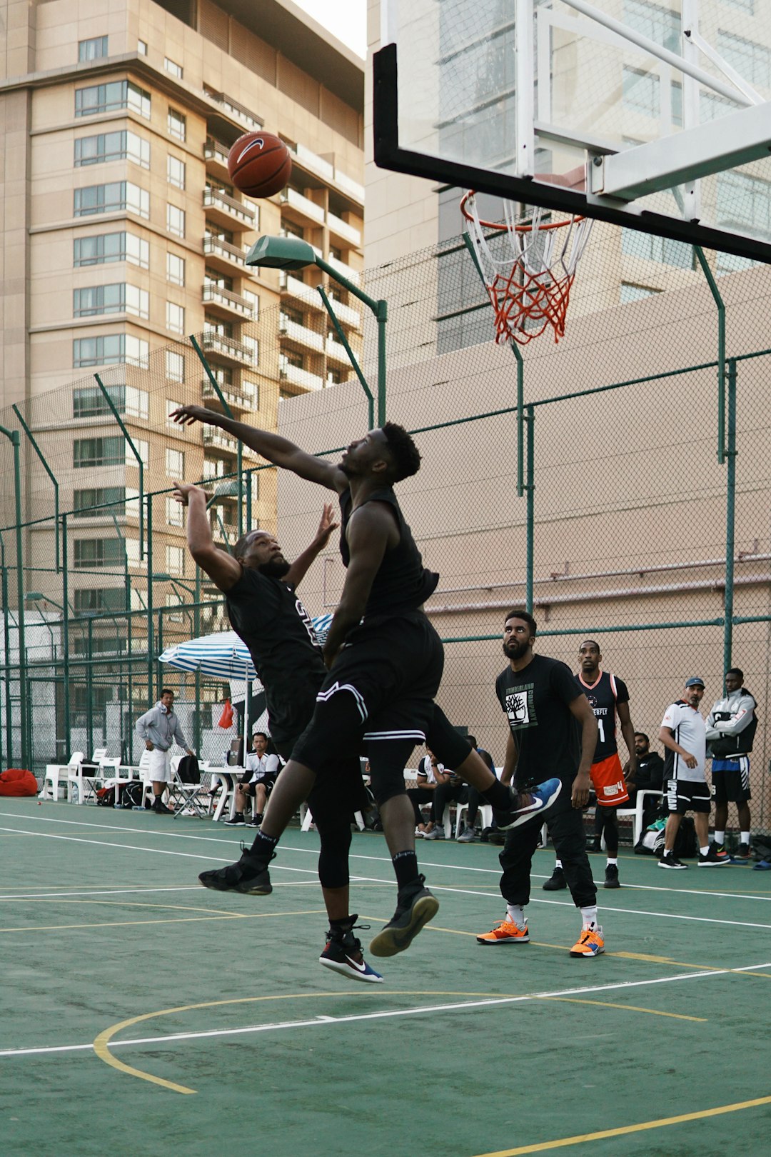 man in black jersey shirt playing basketball
