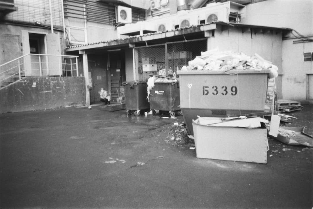 grayscale photo of garbage bins