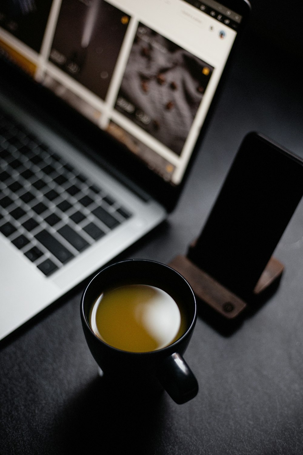 black iphone 5 beside macbook pro