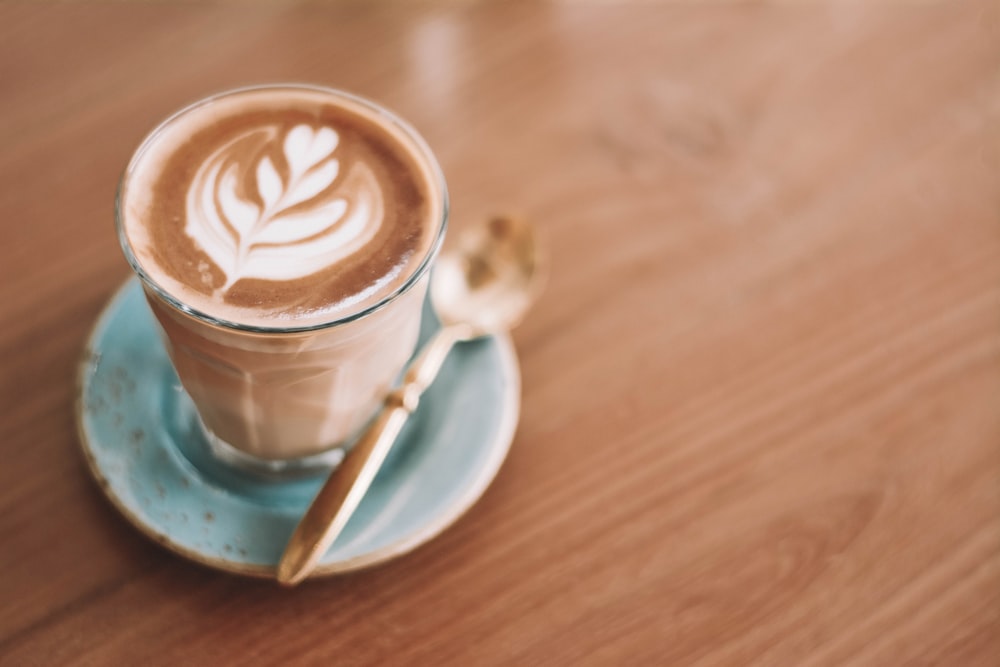 white ceramic mug with coffee on white ceramic saucer