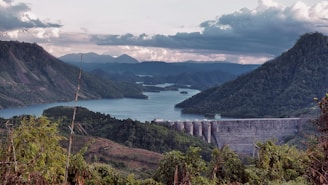 A scenic view of a dam surrounded by lush landscapes.