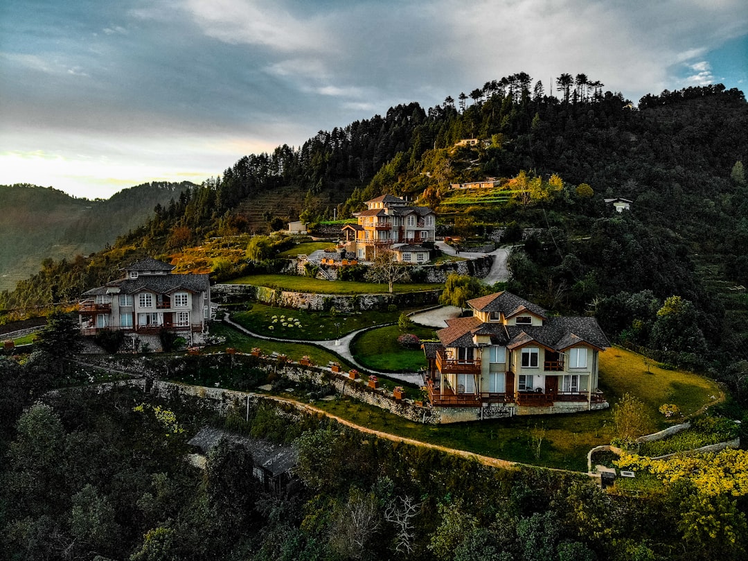 white and brown concrete house on hill,