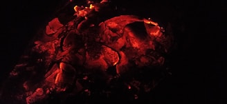 A warm, glowing ember with faint smoke swirling around it.