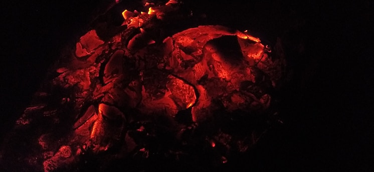 A warm, glowing ember with faint smoke swirling around it.