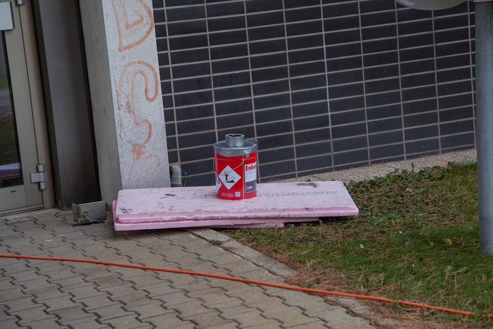 coca cola can on pink and white concrete bench