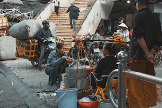 A vibrant scene showing local vendors preparing orders with delivery drivers ready to pick up.