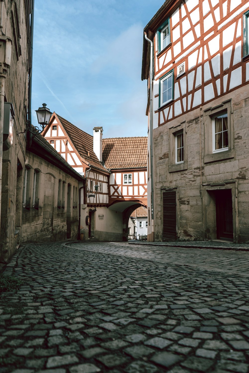 a cobblestone street lined with old buildings