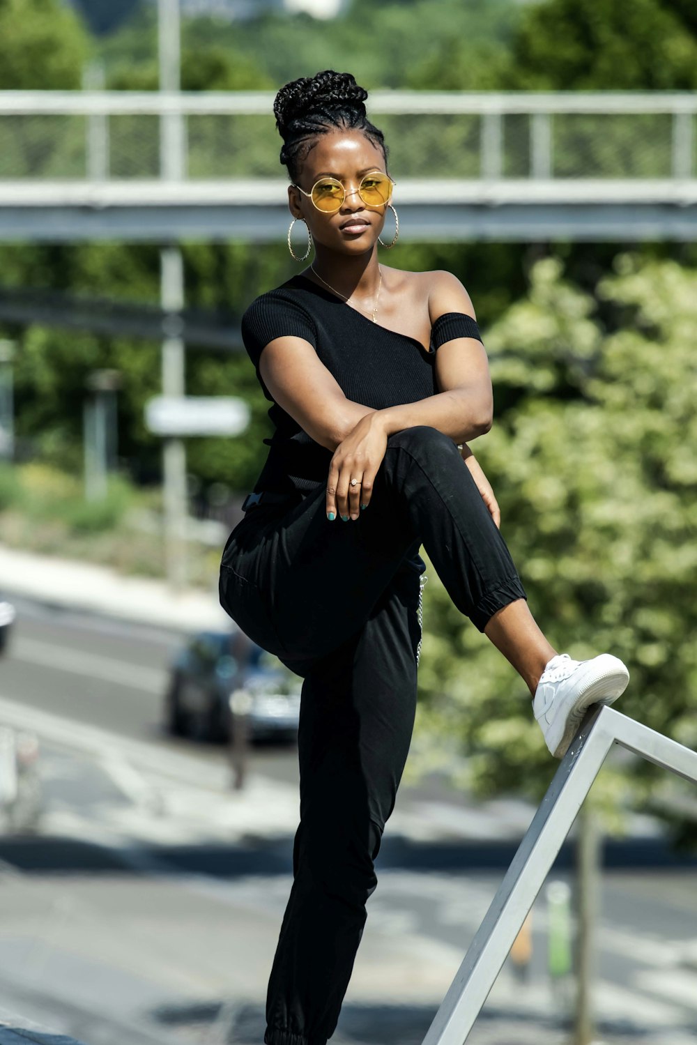 woman in black tank top and black pants wearing yellow goggles sitting on white wooden bench