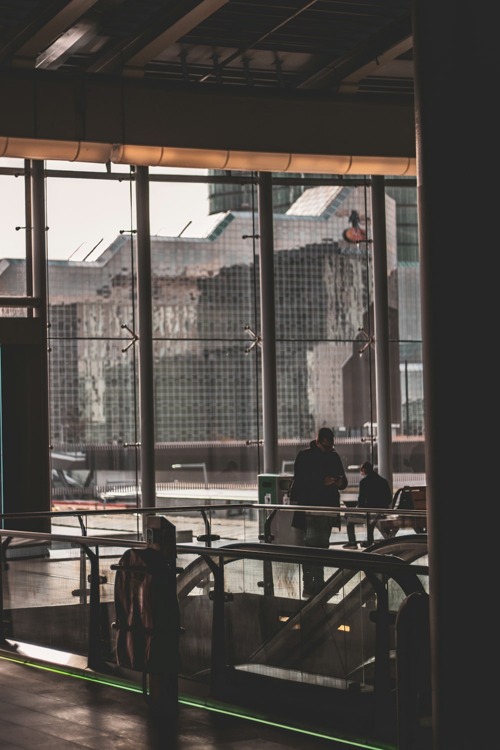 people sitting on chair near glass window