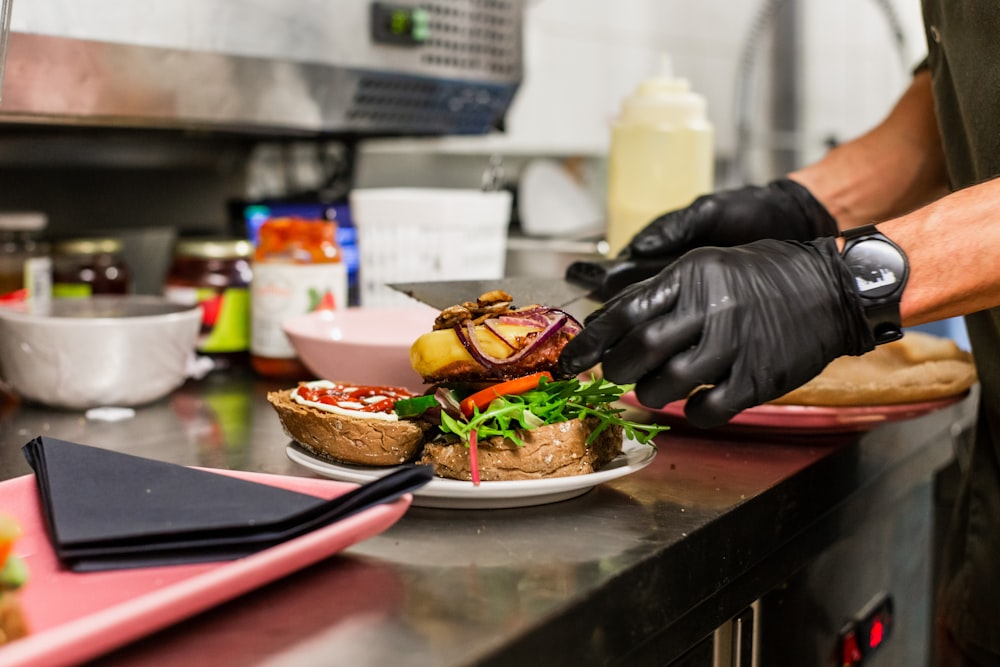 person in black leather jacket holding burger