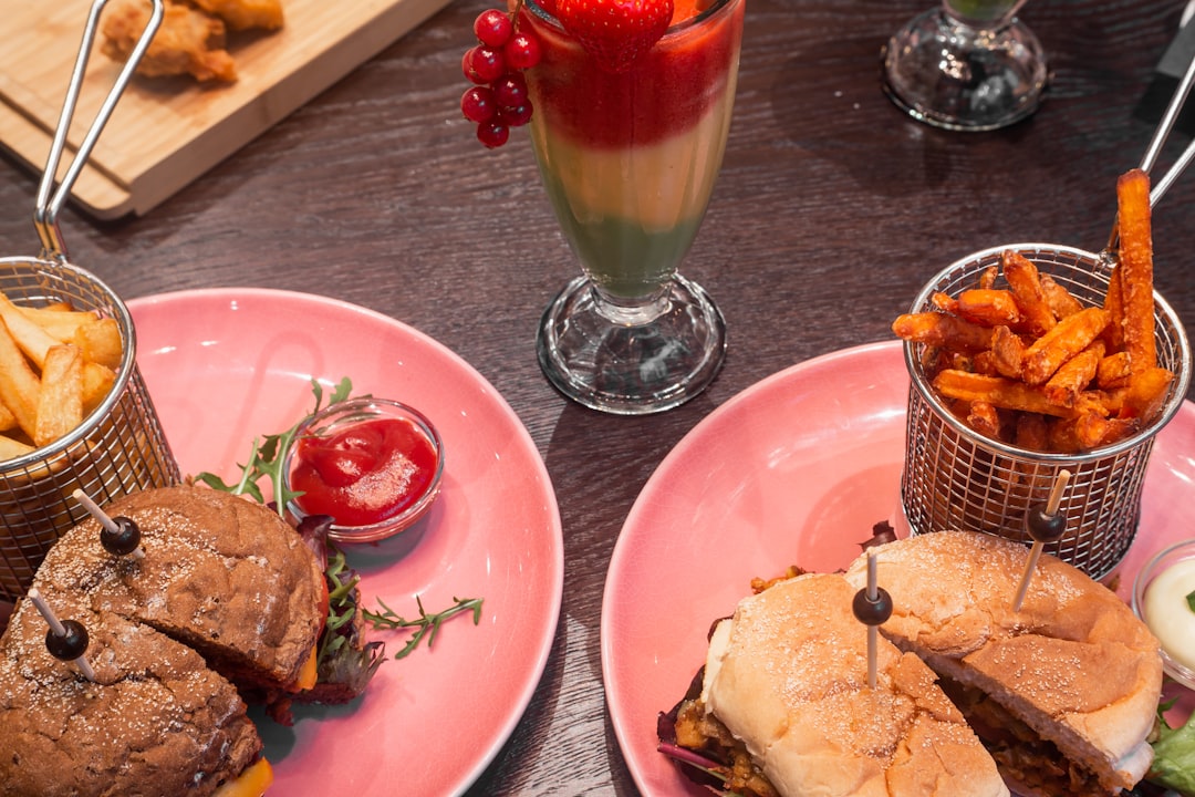 burger and fries on red ceramic plate