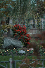 Decorative artificial rocks arranged naturally among colorful ornamental plants in a private garden.