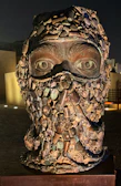 Close-up of a mixed-media sculpture composed of recycled materials.