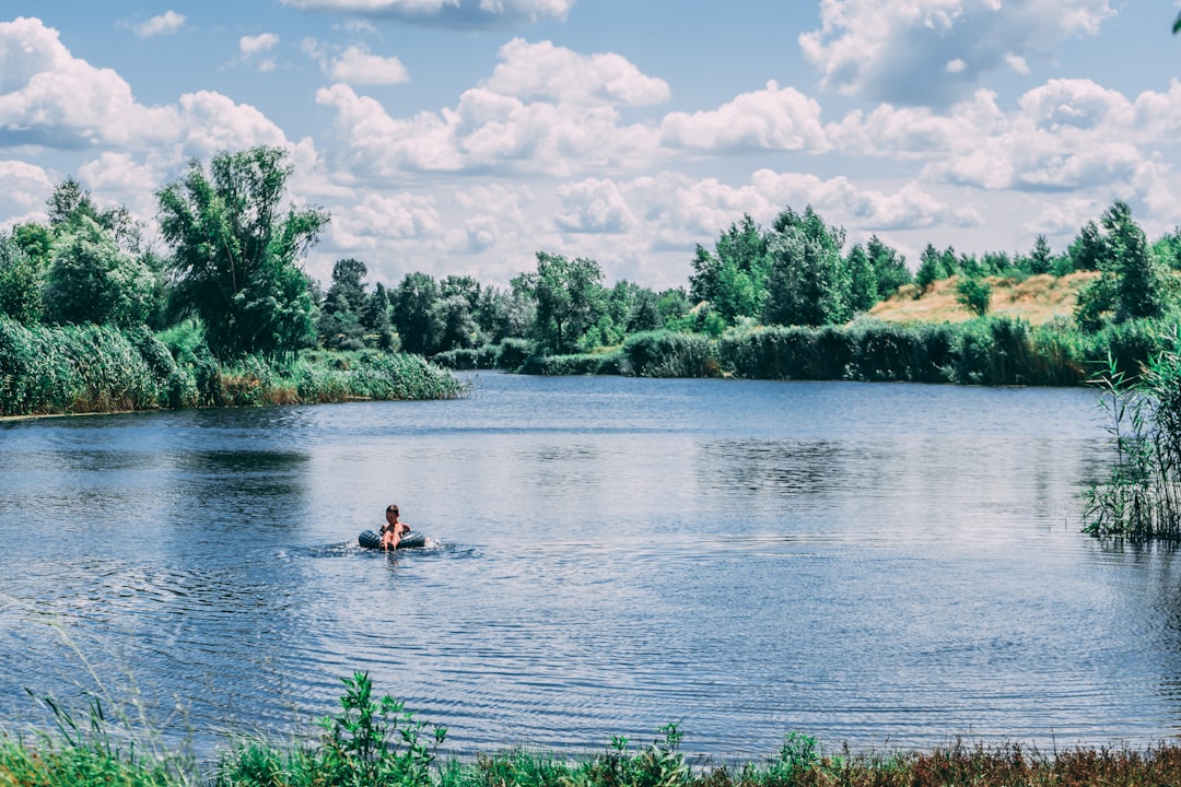 2 people riding on kayak on lake during daytime