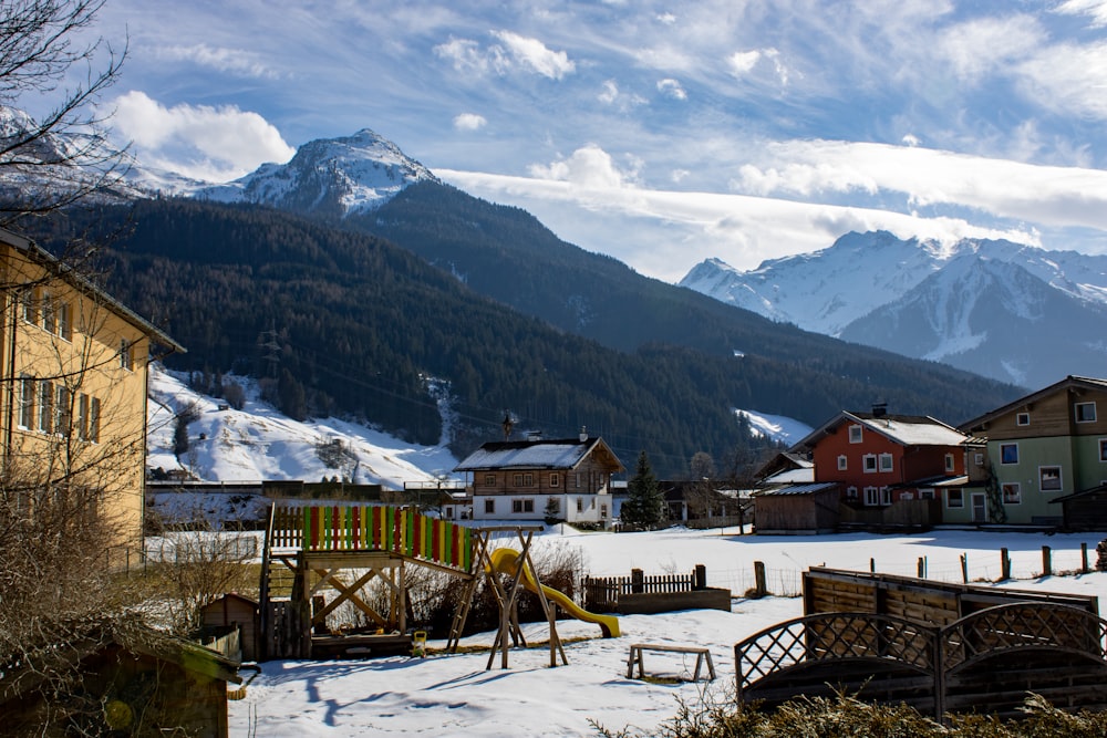 brown wooden house on snow covered ground near mountains during daytime