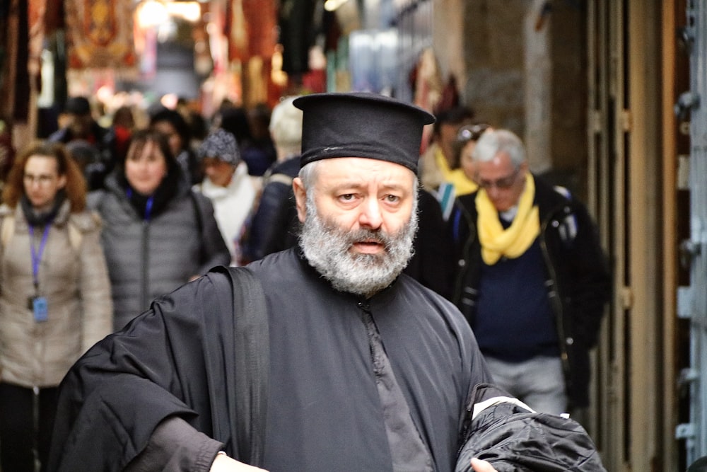 man in black coat and black hat