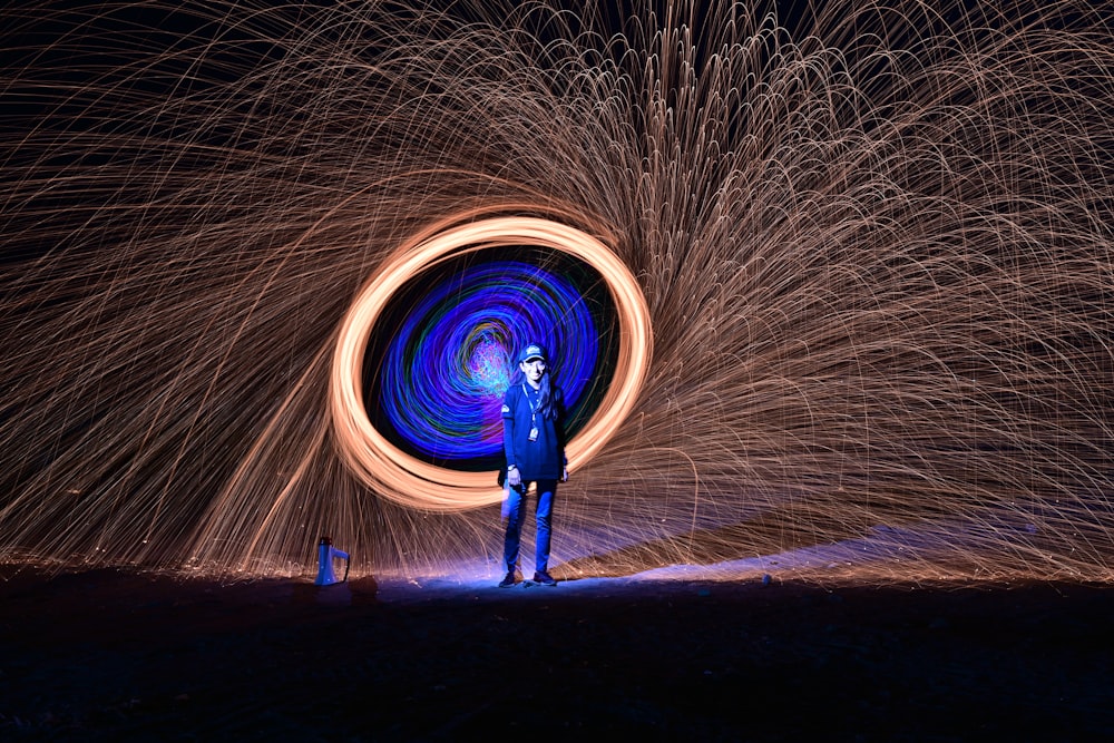 man in blue jacket standing on steel wool photography