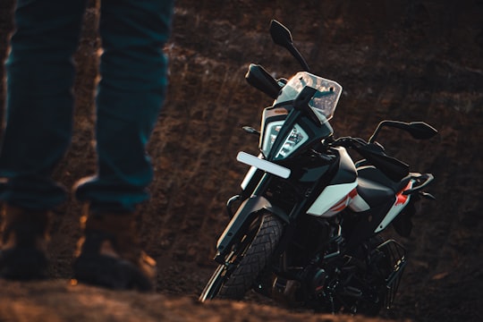 white and black motorcycle on brown dirt in Nagpur India