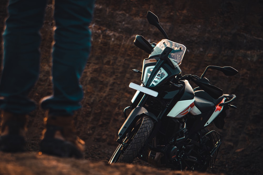 white and black motorcycle on brown dirt