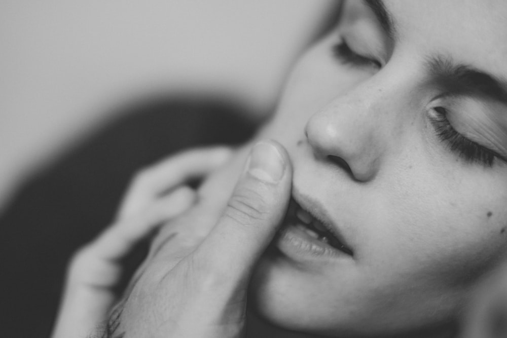 grayscale photo of womans face