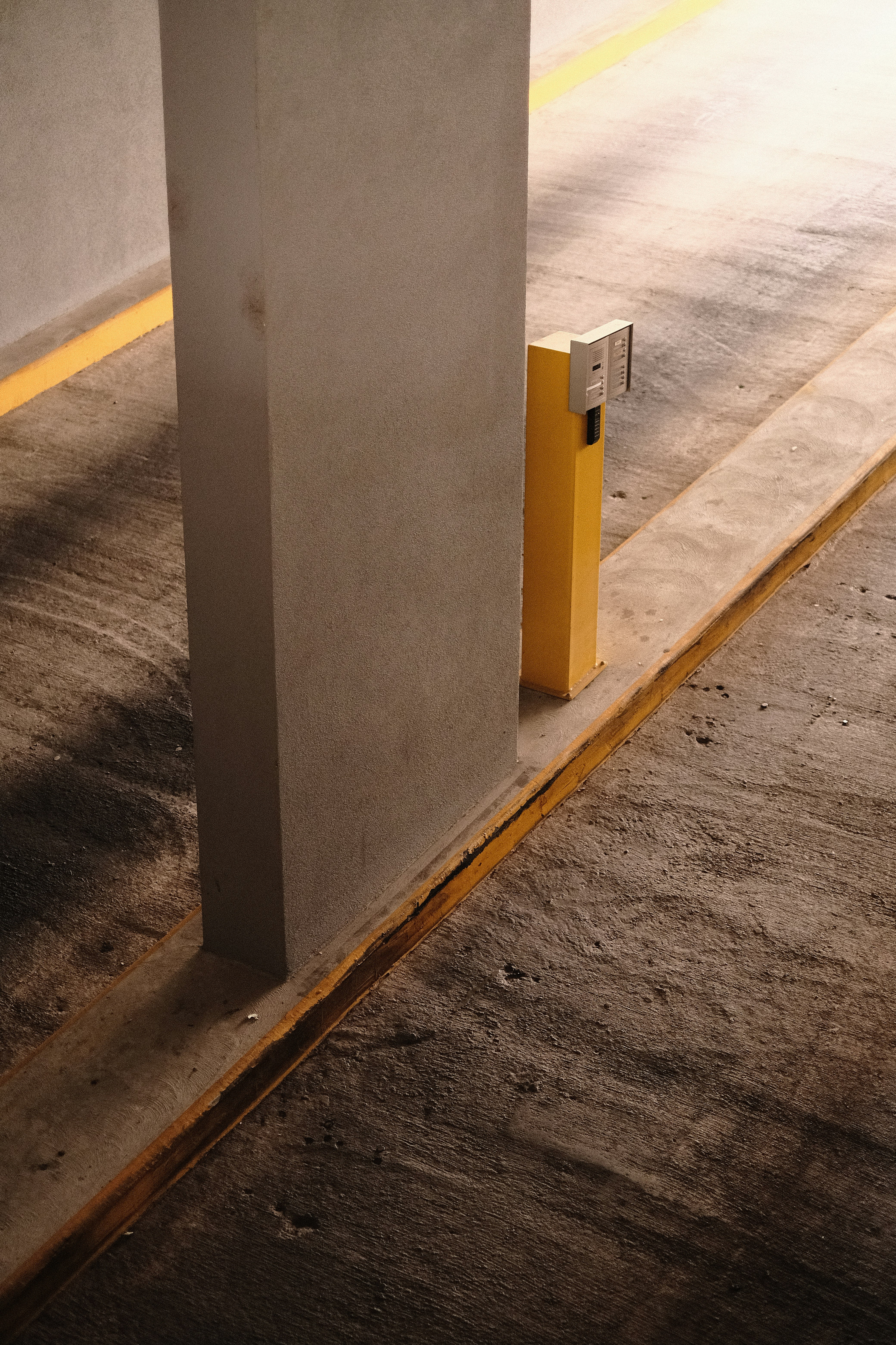 white concrete post on gray concrete floor