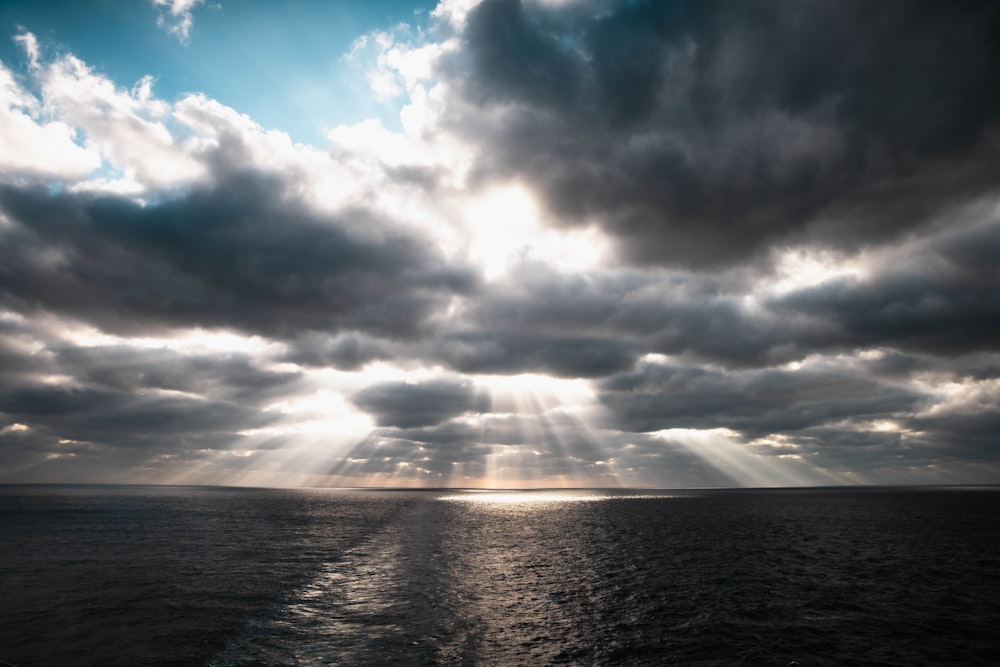 body of water under cloudy sky during daytime