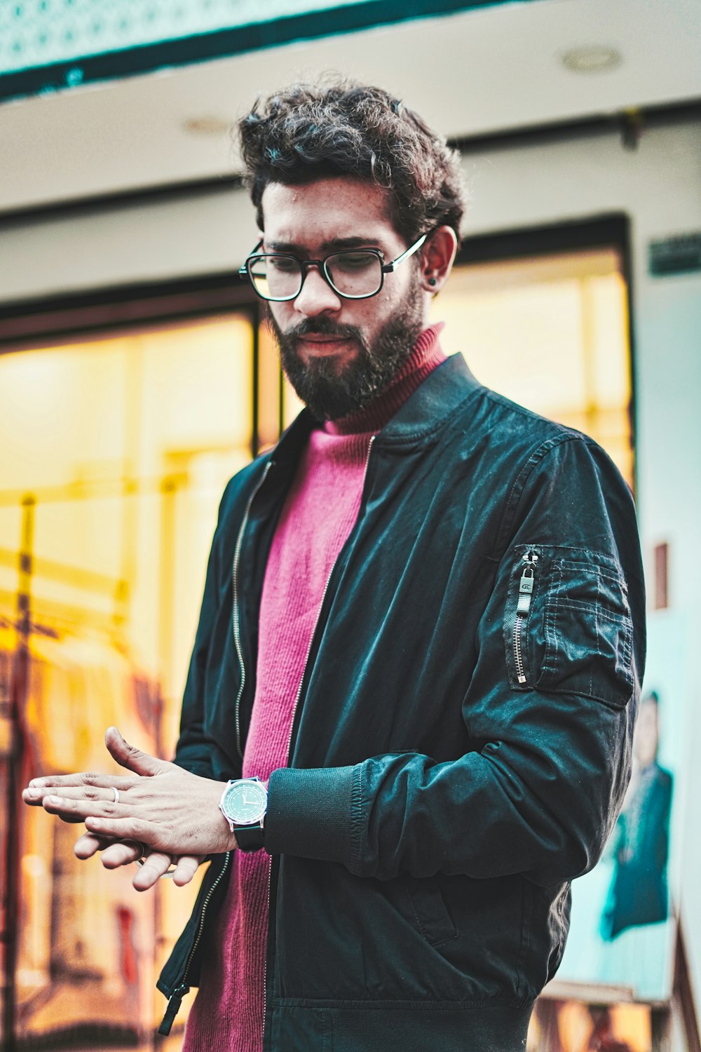 man in black leather jacket wearing eyeglasses