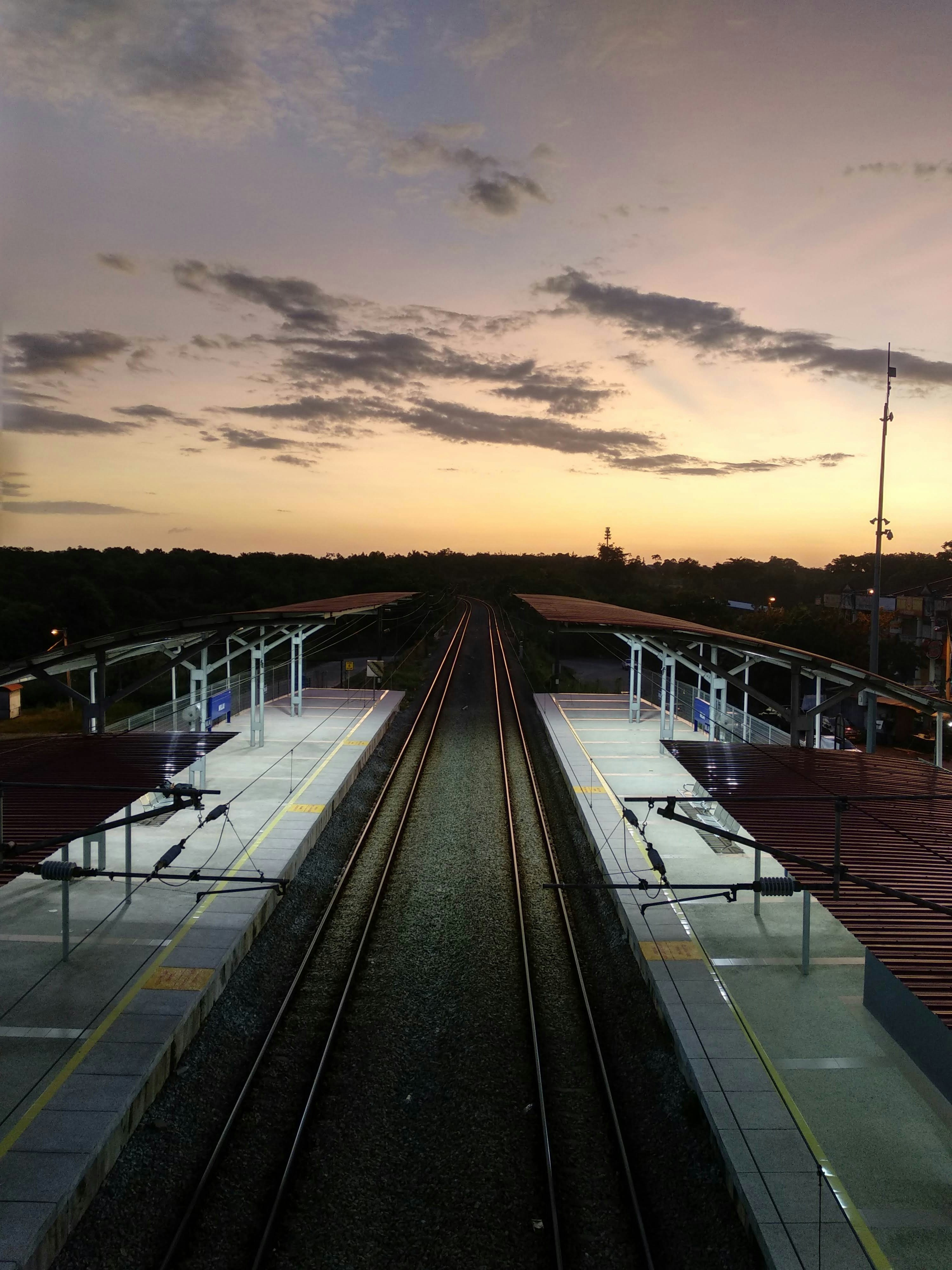 white and black boat on dock during sunset