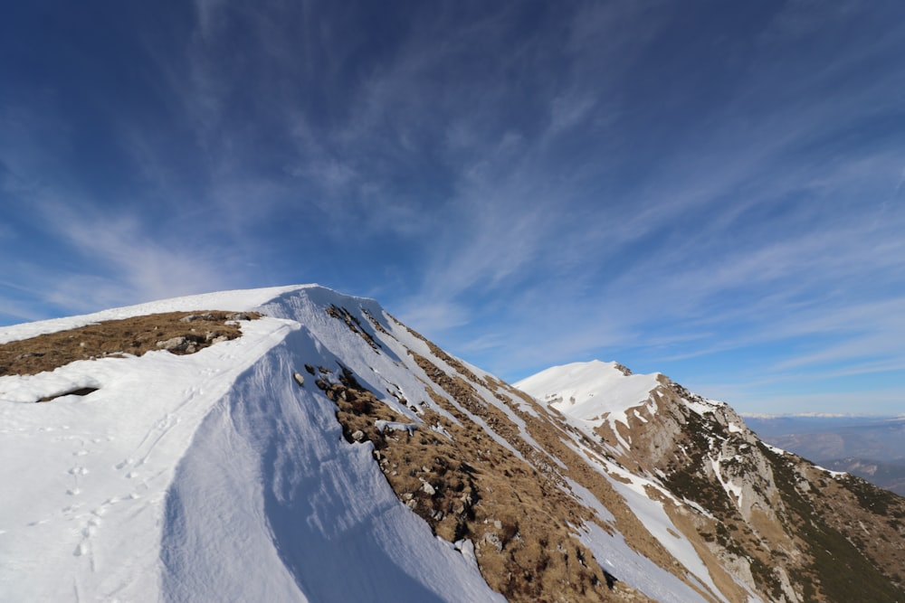 snow covered mountain under blue sky during daytime