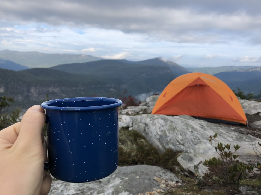 blue plastic cup on gray rock