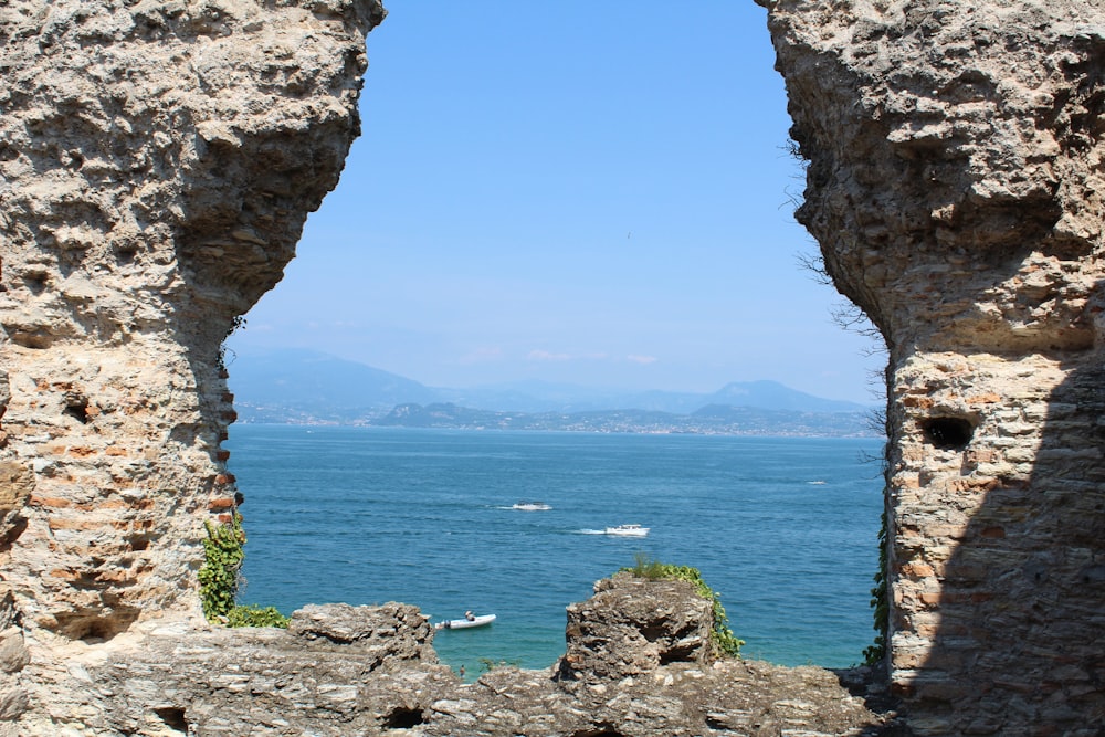 brown rock formation near body of water during daytime