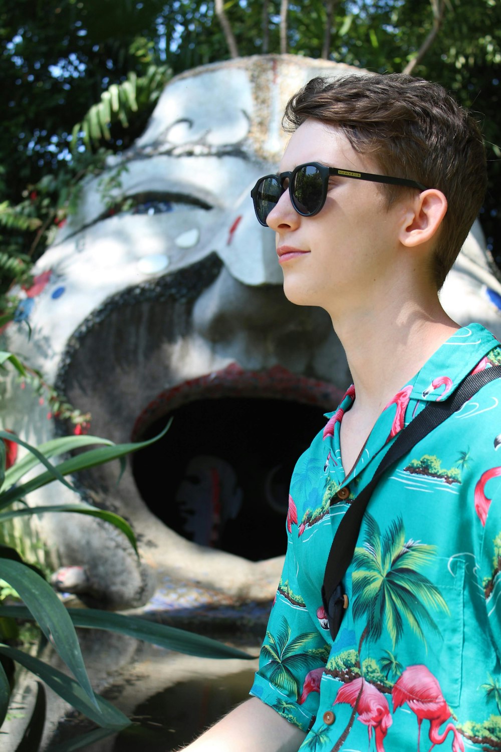 woman in blue and red floral button up shirt wearing black sunglasses