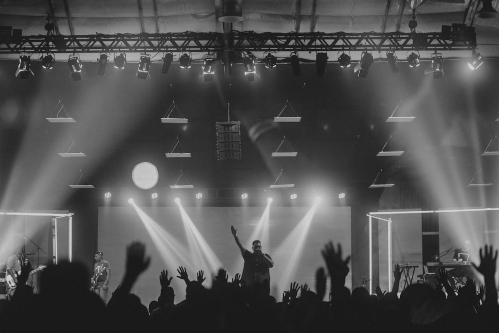 a crowd of people standing on top of a stage