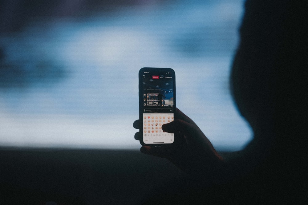 person holding black iphone 4