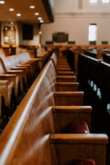Empty courtroom pews representing private commercial arbitration services.