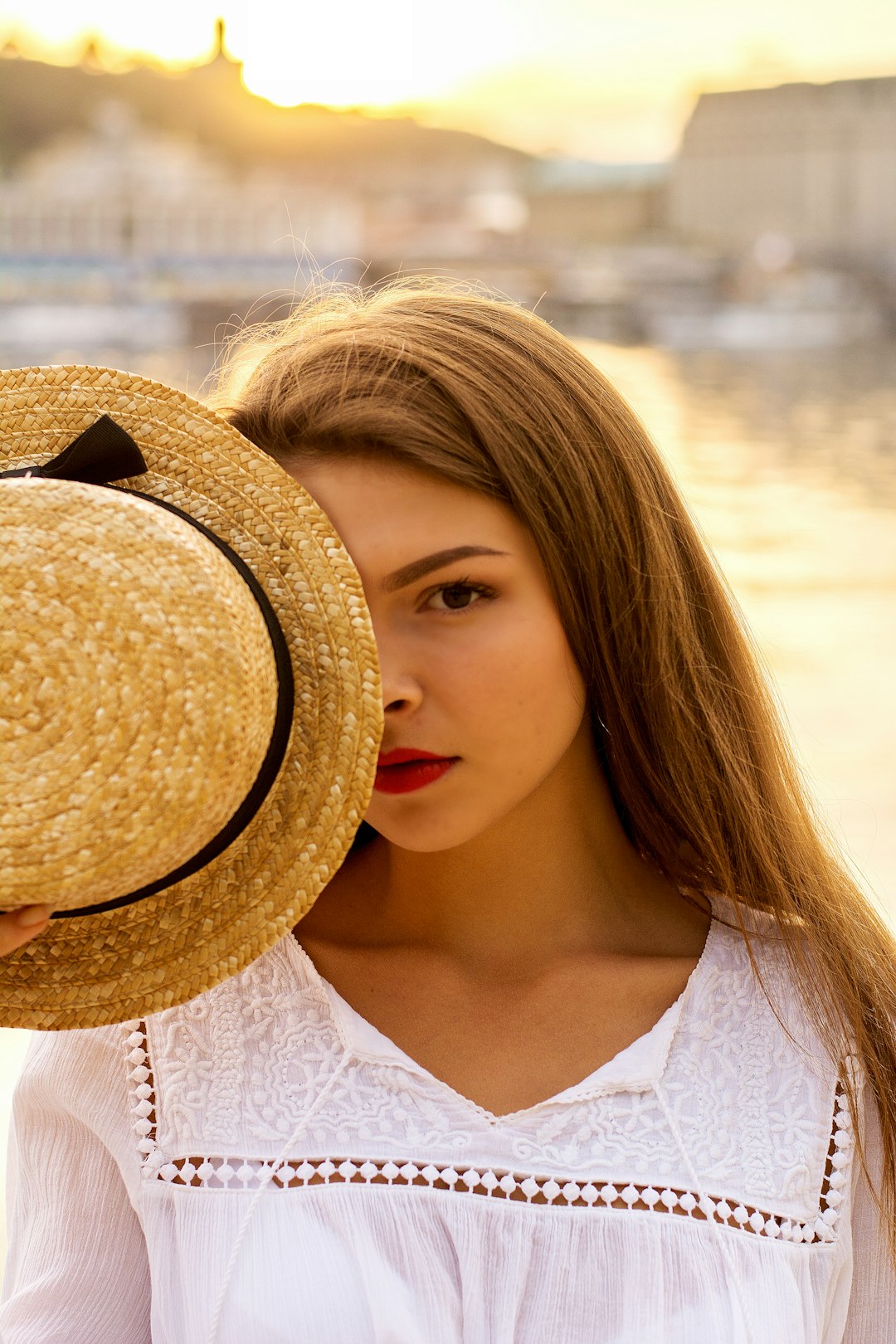 woman in white shirt wearing brown sun hat