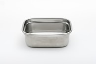A rectangular stainless steel container with rounded corners against a plain white background. The metal surface is smooth and shiny, reflecting light subtly.