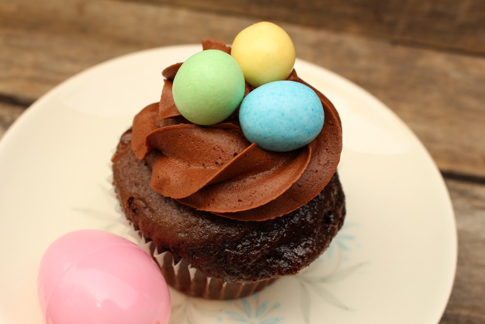 chocolate cake with green and yellow egg on white ceramic plate