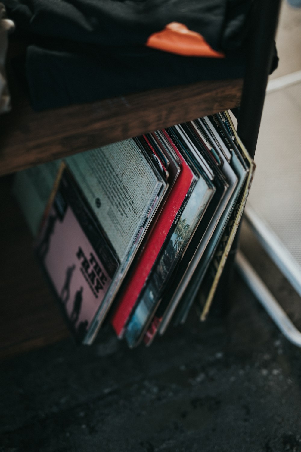 a stack of records sitting on top of a wooden table