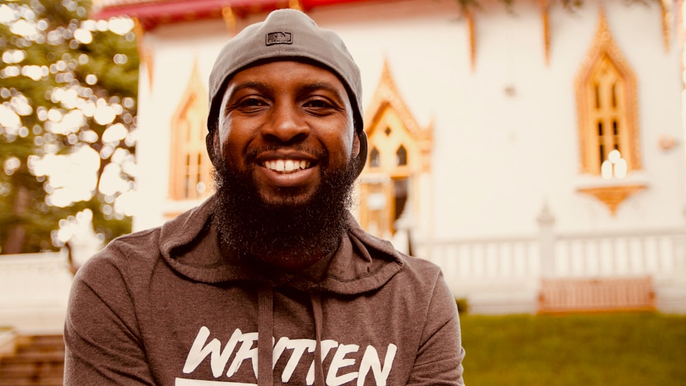 man in gray and white pullover hoodie smiling