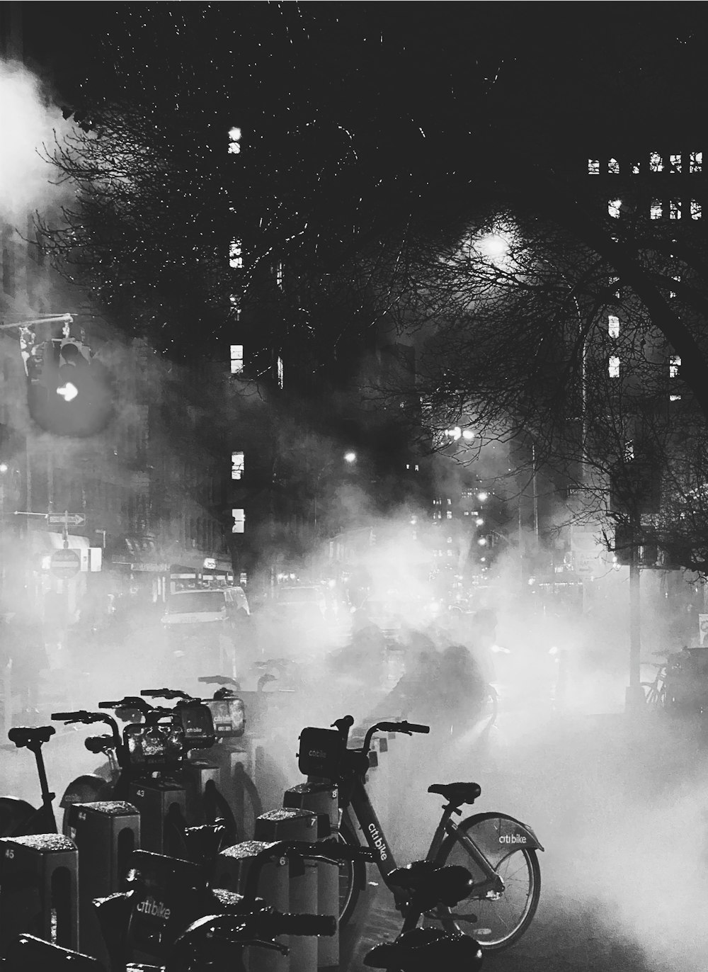 a black and white photo of a bike in the fog