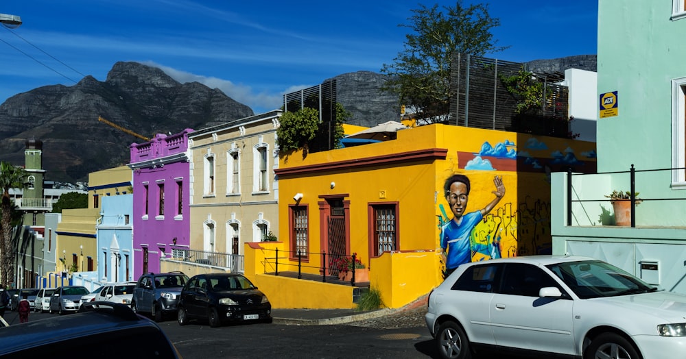 man in blue jacket standing beside yellow concrete building during daytime