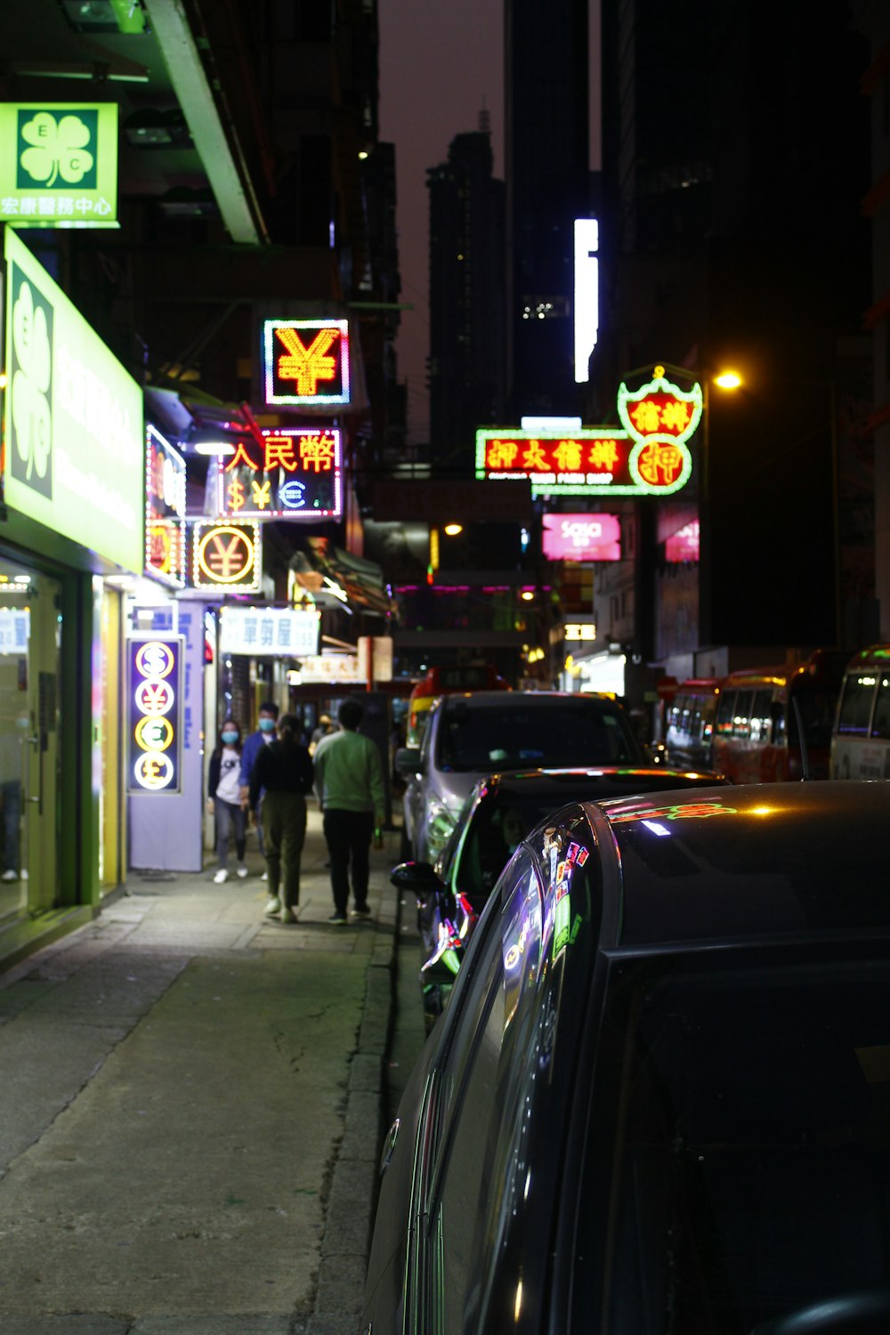 people walking on sidewalk during night time