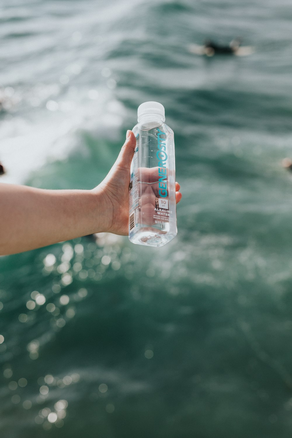 person holding white plastic bottle