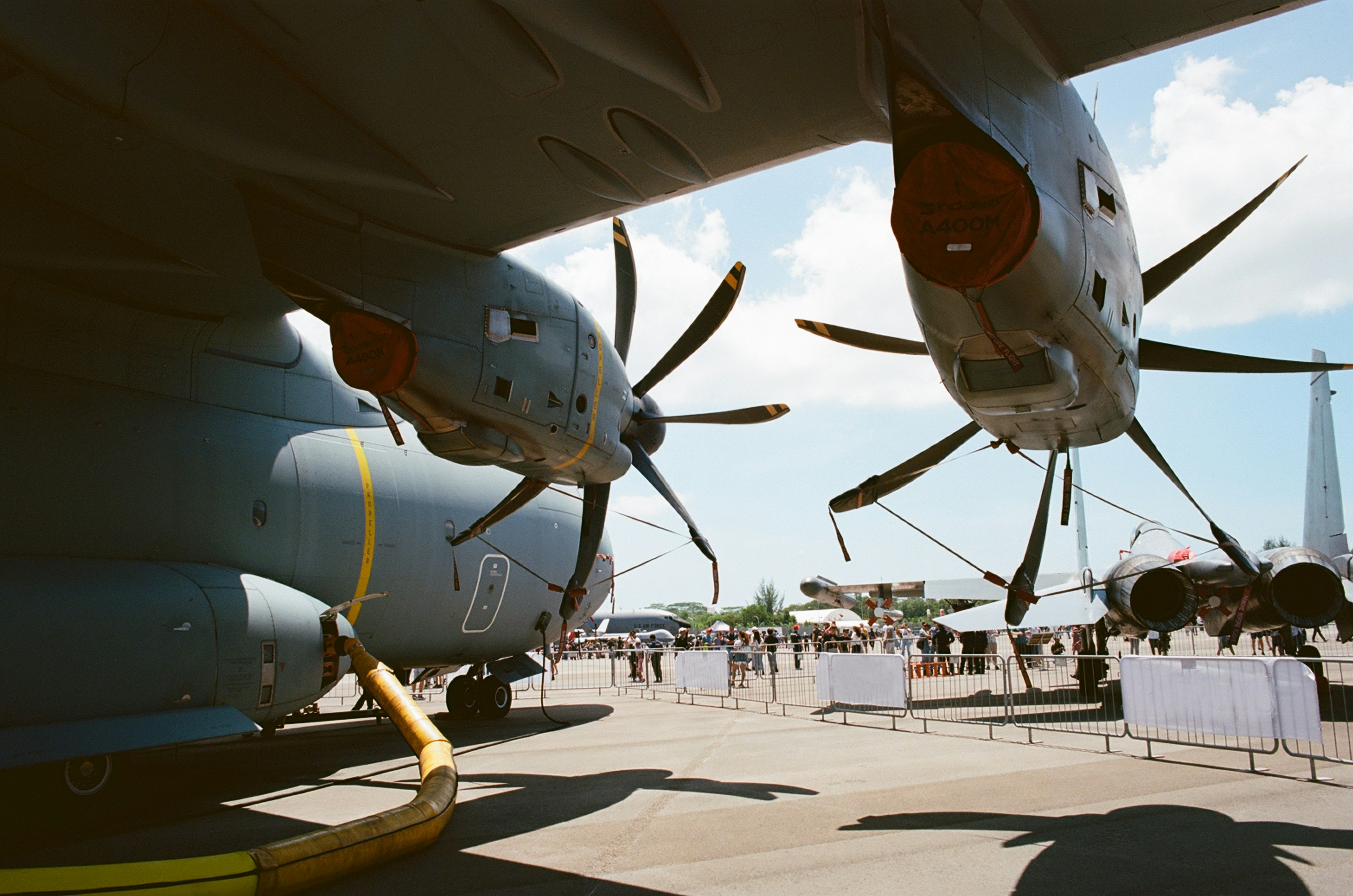 people standing near gray airplane during daytime, C-130 Hercules at the Singapore Airshow shot on Kodak Ektar 100.