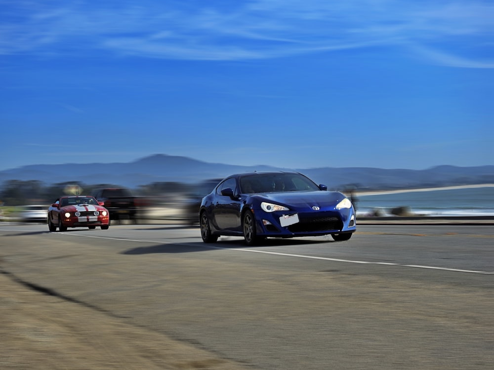 black sedan on gray asphalt road during daytime