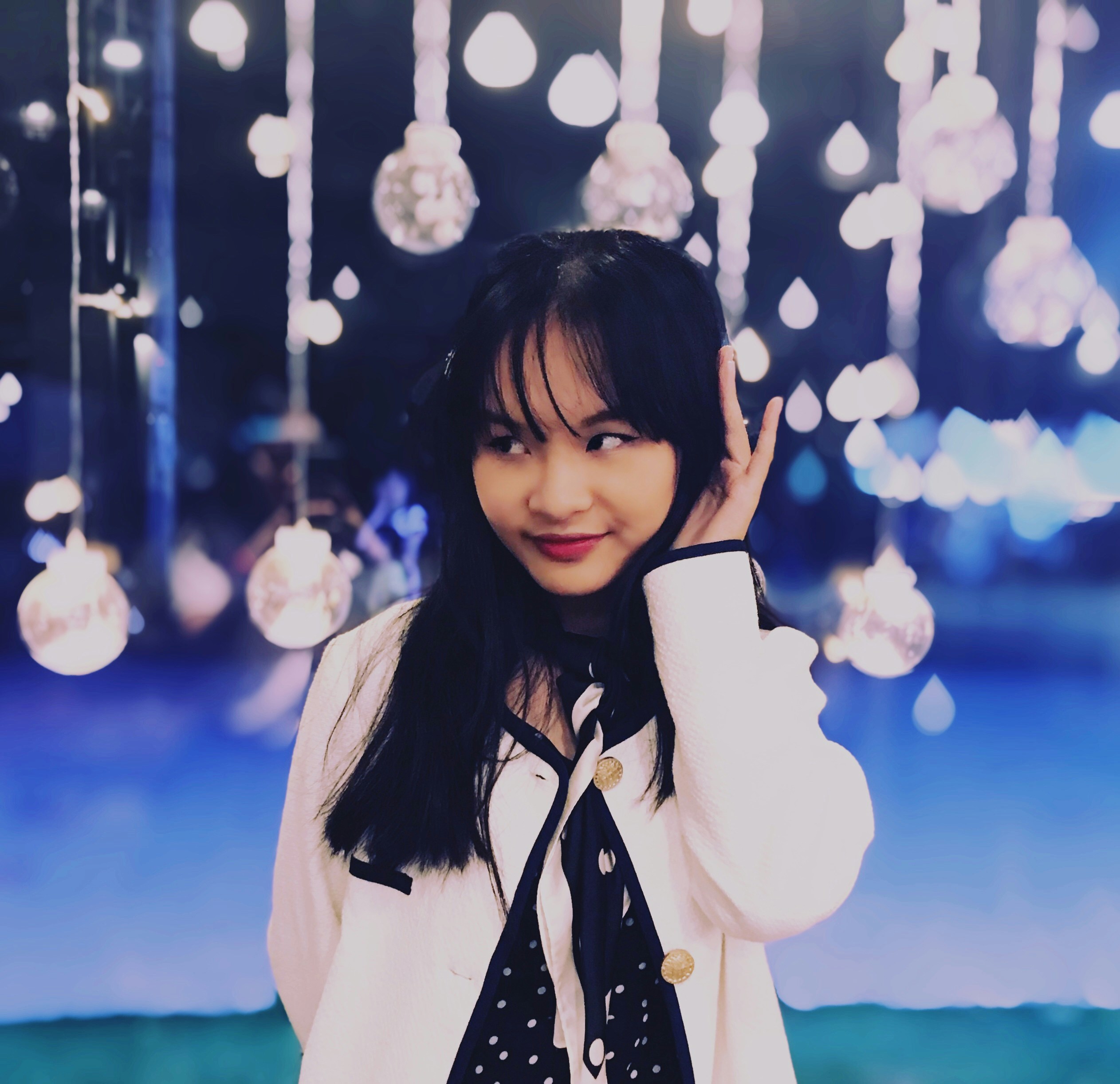 woman in white coat holding white ceramic mug