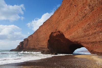 brown rock formation on sea shore during daytime